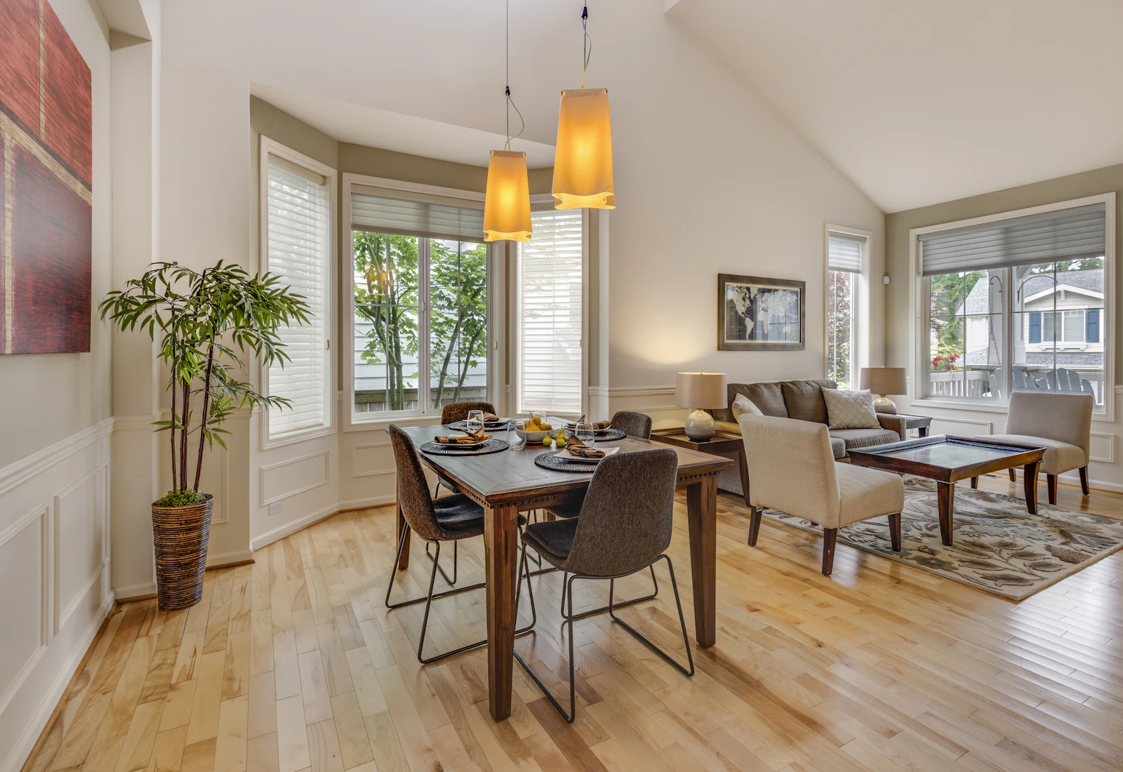 Empty room with white walls and a pale wood floor.