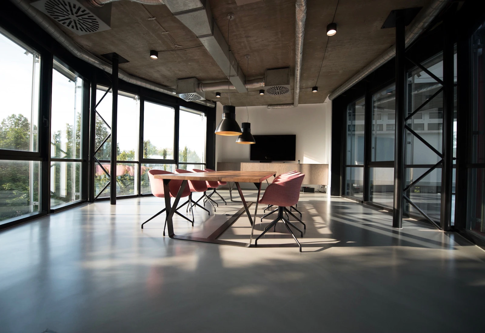 Conference room with a long table and black chairs.