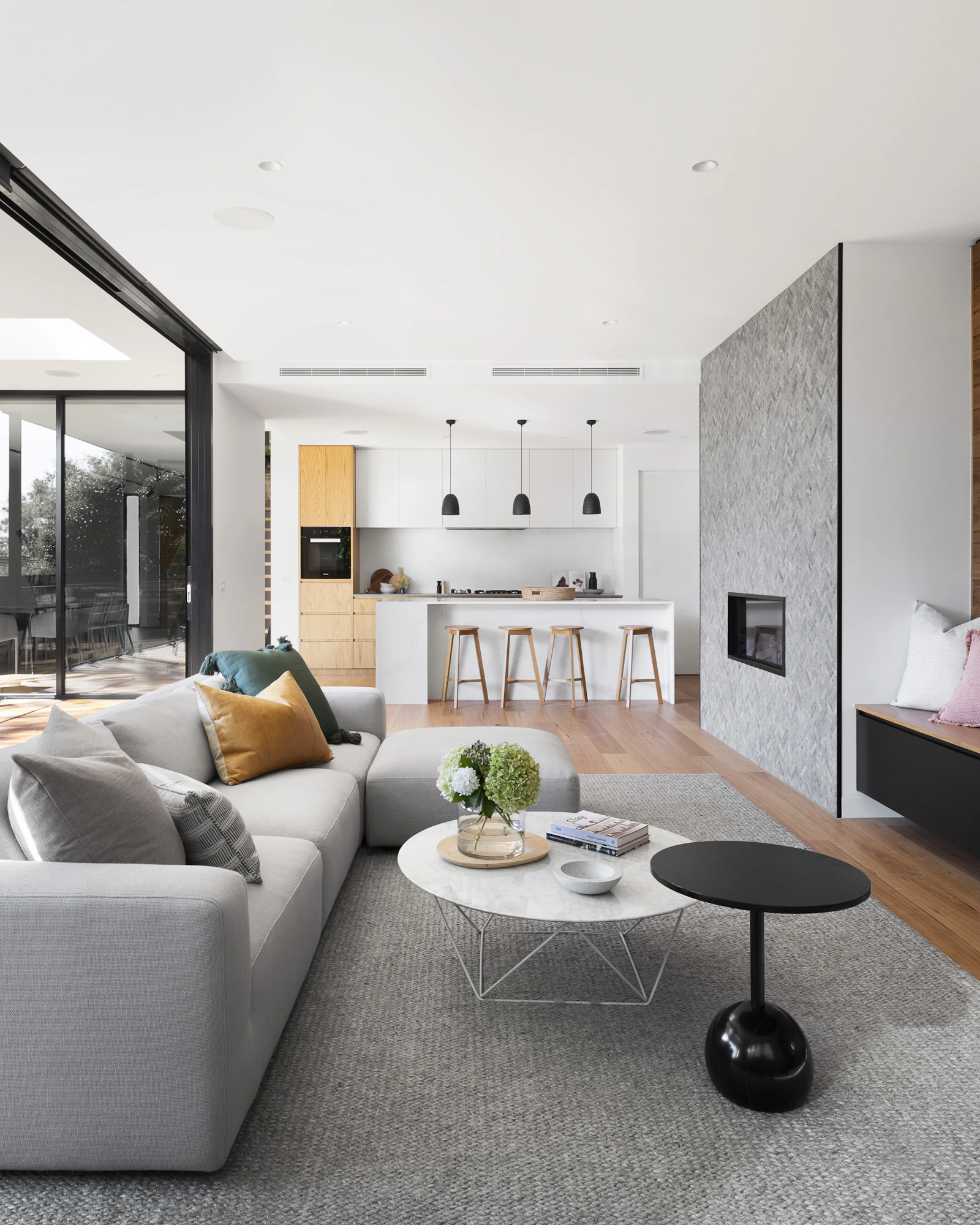 Tall windows with soft daylight and a view of trees.